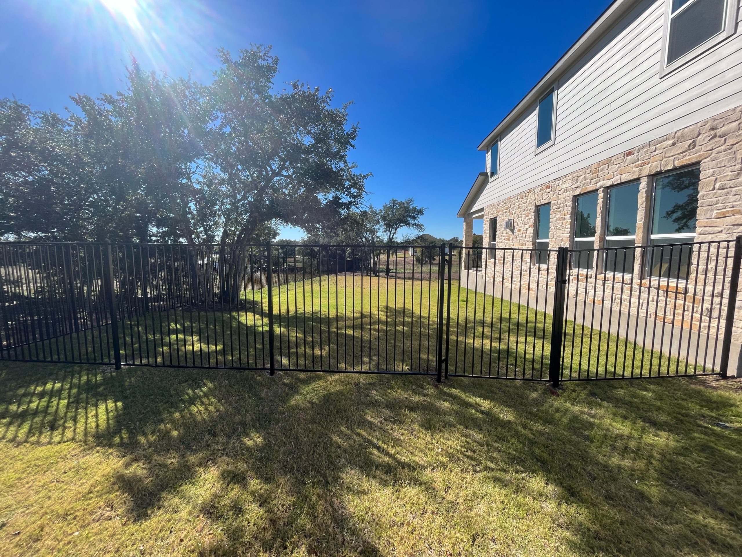 Green lawn with iron fence